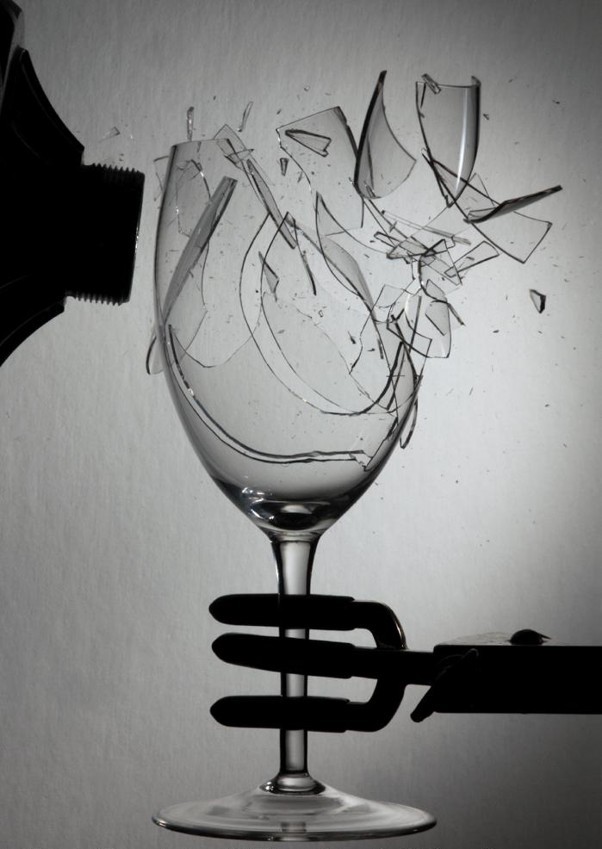 A wine glass shattering from the resonance of sound